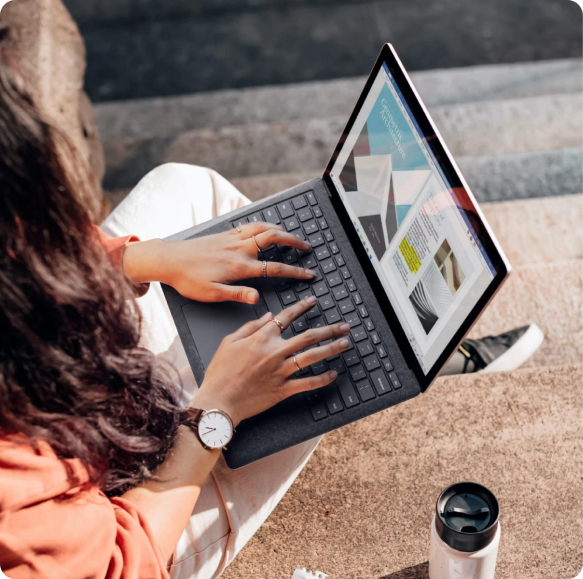 Person working on a laptop while reviewing ecommerce customer workflows